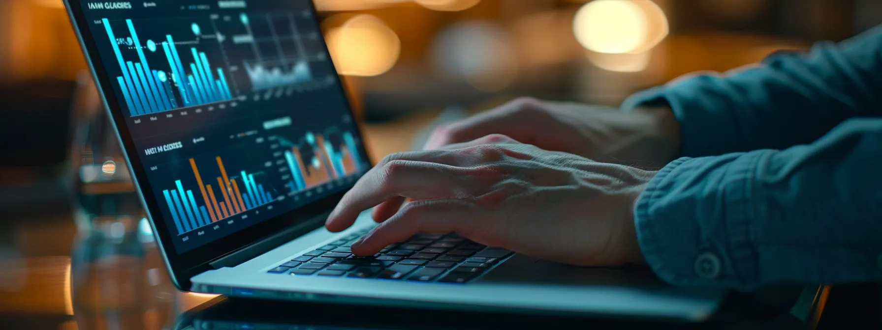 Hands typing on a laptop displaying colorful data analytics graphs, symbolizing digital marketing and local SEO strategies for cleaning services.